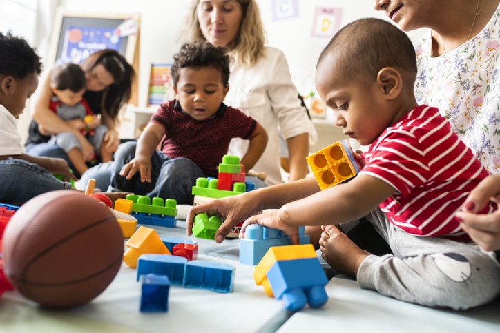Diverse toddlers enjoying playing with toys.